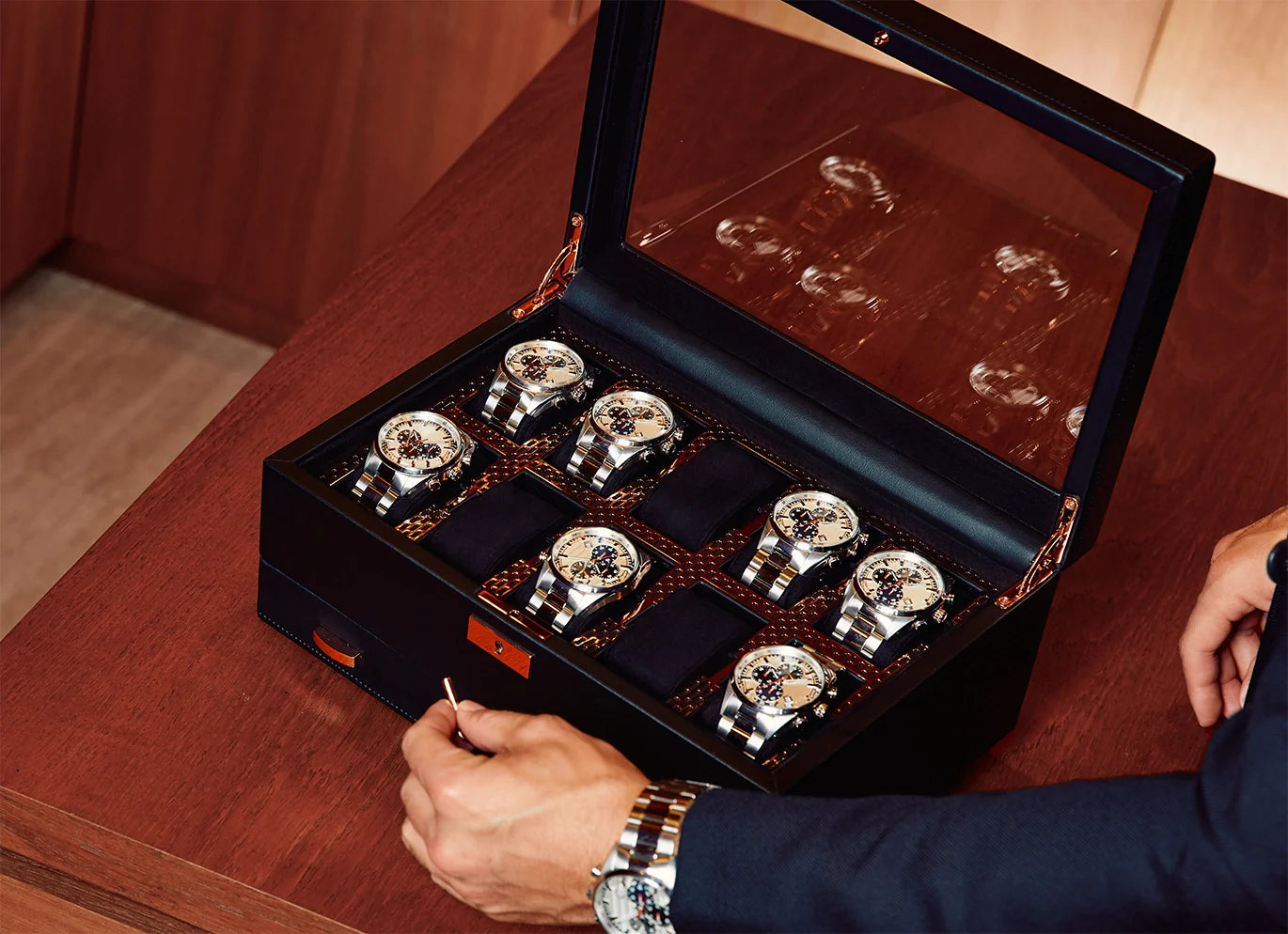 Femme tenant une boîte à bijoux de voyage et contemplant une grande boîte à bijoux bleue